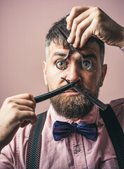 Barber with scissors for work. Tools for barbeshop.