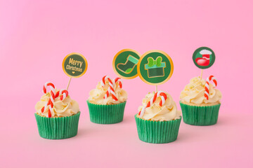 Tasty Christmas cupcakes on color background