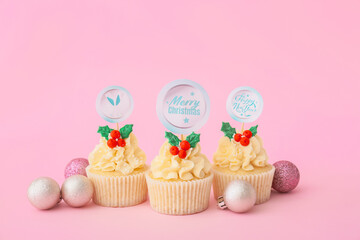 Tasty Christmas cupcakes on color background