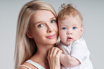 Mother and baby playing and smiling. Happy family.