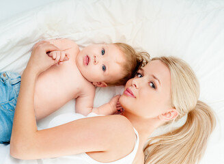 Mother and baby playing and smiling. Happy family.