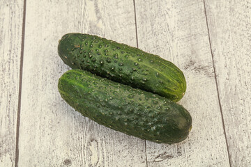 Green fresh cucumbers over background