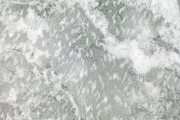 top view of the lake with frozen ice and a beautiful pattern on it