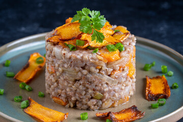 Boiled buckwheat with fried carrots and onions, close up