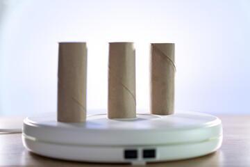 Three cardboard rolls of the worn out toilet paper, symbol of the pandemic. Diagonal photo.