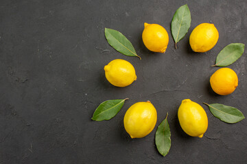 top view fresh sour lemons lined on a dark background fruit citrus yellow lime
