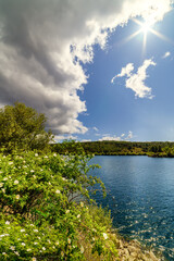 Fototapeta premium Lake with clouds, blue sky and reflections in the water. Atazar Reservoir Madrid 