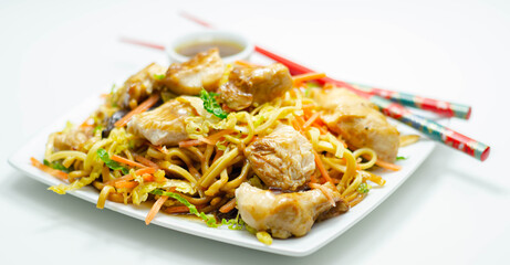 Cooked chicken breast pieces with savory garlic and ginger soy sauce and  noodles, black fungus mushrooms, savoy cabbage, and carrot