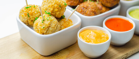 Various mini chicken kievs and sweet potato falafels served with sauces