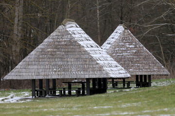 Leisure gazebo in the woods and garden with a snow-covered roof. Winter seasons. Kaunas, Lietuva