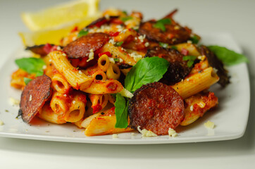 Pennette pasta in a spicy tomato sauce with sliced pepperoni, mozzarella, and mature cheddar cheeses
