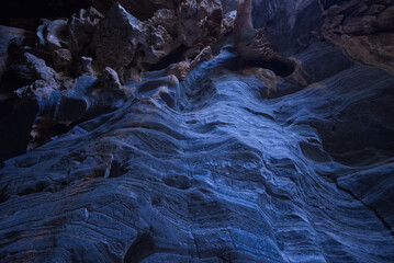 Blue striped stone of cave wall  