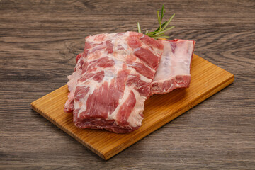 Raw pork ribs served rosemary