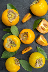top view fresh sweet persimmons with leaves on dark background ripe tree taste fruits