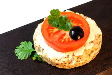 A healthy homemade snack. Rice crunchy with mozzarella, tomato, olive and cilantro on a kitchen blackboard.