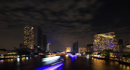Fototapeta na wymiar Long exposure lighting of Night cityscape at the Chao Phraya river in Bangkok ,Thailand