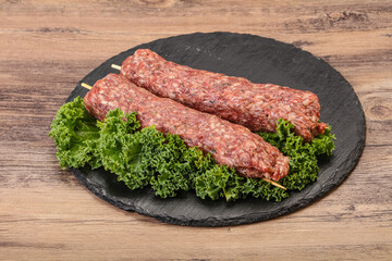 Raw minced beef kebab skewer