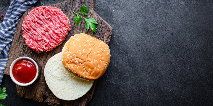burger raw meat set cutlet, bun bread, tomato sauce and more ready to eat on the table for making meal snack top view copy space for text food background rustic image