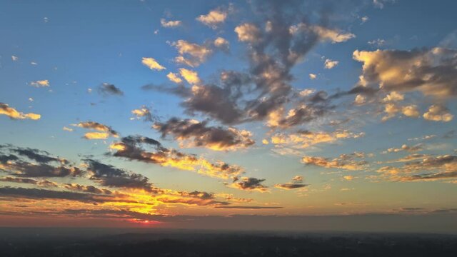 Large beautiful sun beam orange sunset sky dramatic time lapse sunset over clouds evening majestic sunset