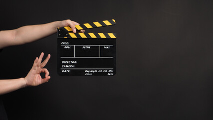 hands is holding clapper board or movie slate.It is used in video production and film industry on...