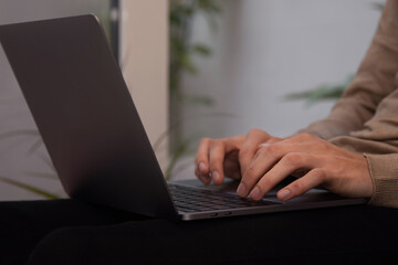 close-up of hands typing on computer