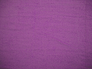the dense texture of a purple thick towel . lilac background