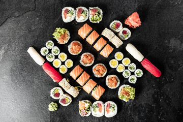 Obraz na płótnie Canvas Sushi Rolls. Sushi Rolls Set, maki, philadelphia and california rolls, on a Black background.