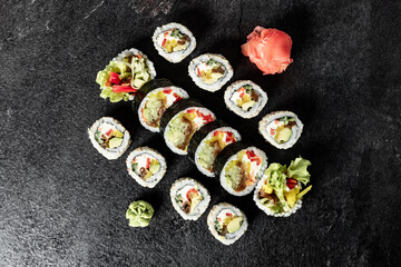 Fototapeta na wymiar Sushi Rolls. Sushi Rolls Set, maki, philadelphia and california rolls, on a Black background.