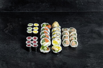Sushi Rolls. Sushi Rolls Set, maki, philadelphia and california rolls, on a Black background.