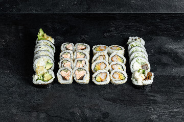 Sushi Rolls. Sushi Rolls Set, maki, philadelphia and california rolls, on a Black background.