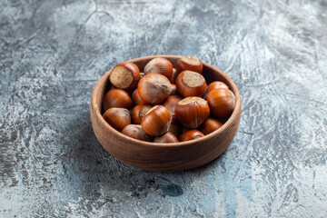 front view fresh hazelnuts inside plate on white background nut walnut peanut