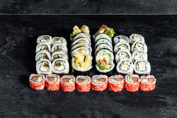 Sushi Rolls. Sushi Rolls Set, maki, philadelphia and california rolls, on a Black background.