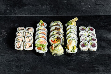 Sushi Rolls. Sushi Rolls Set, maki, philadelphia and california rolls, on a Black background.