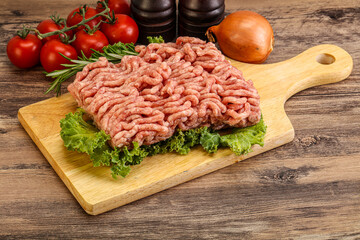 Raw pork minced meat over board