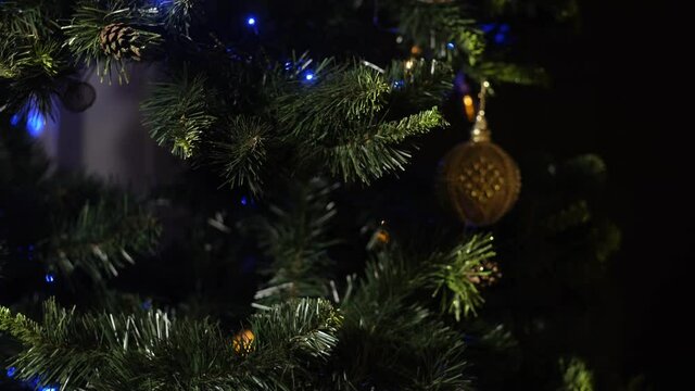 the process of decorating a Christmas tree with New Year's toys and garlands for the New Year