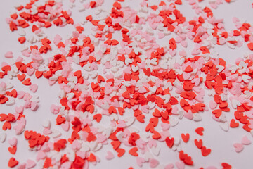 Many multicolored sugar hearts on a white background. Valentine's day concept. Selective focus.