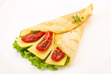 Pancake with cheese and dry tomato
