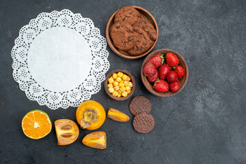 Fototapeta na wymiar top view sweet biscuits with fruits on dark background sweet cookie color photo