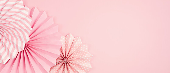 Festive party banner background with pink paper circle fans over pastel background. Festival, birthday, baby shower decoration
