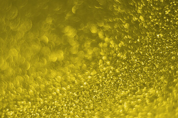 Illuminating Pantone Color Of The Year 2021. Abstract festive bokeh background with shining defocus sparkles. Blurred glitters shimmering dust macro close up, copy space for text logo