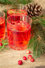 Refreshing drink cranberry and rosemary cocktail on the rustic background.