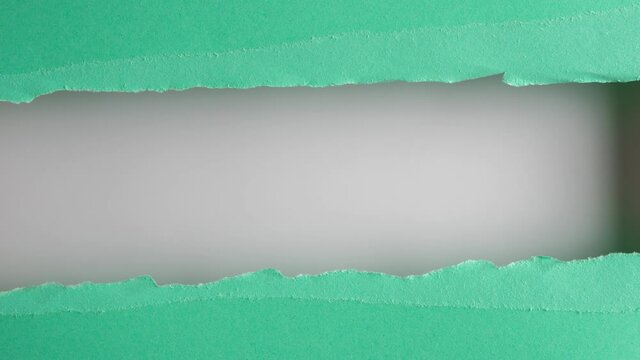 Turquoise paper is torn over white background for message, stop motion, animation. Template for your text.