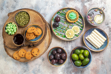 top view little cake with fruits and candies on light desk dessert sweet biscuit