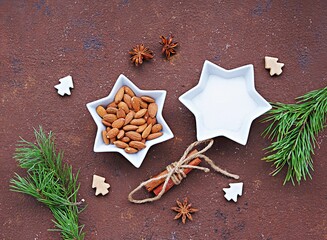Ingredients for cooking candied almonds on a brown concrete background. Christmas sweets concept.