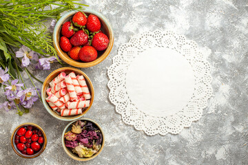 Fototapeta na wymiar top view fresh red strawberries with flowers on white background berry fruit red candy