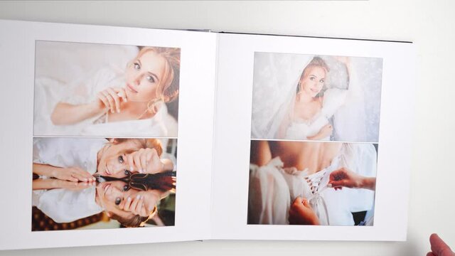 top view. woman leaf through the wedding photobook. 