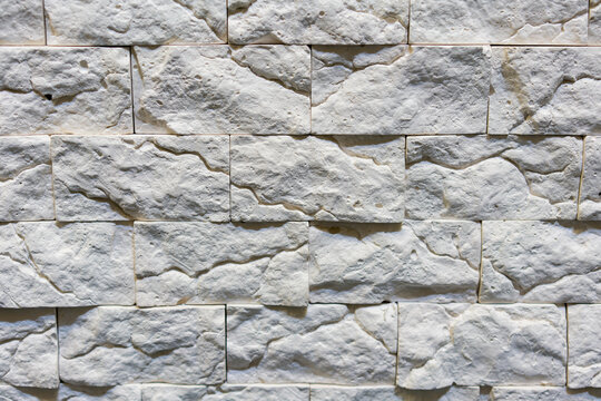 Seamless texture of white decorative stacked stone, natural stone cladding. brick background. close up. Background. toned