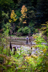 Fototapeta premium Male tourist standing in lake