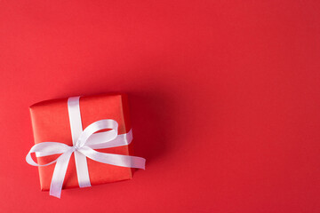 happy holidays concept. Above overhead close up view photo of packed gift box with white ribbon isolated bright color red background