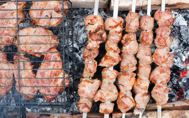 Delicious grilled pork meat in BBQ Barbecue with pork meat. Kebabs on the grill. Close-Up Of Meat On Barbecue Grill With Smoke.